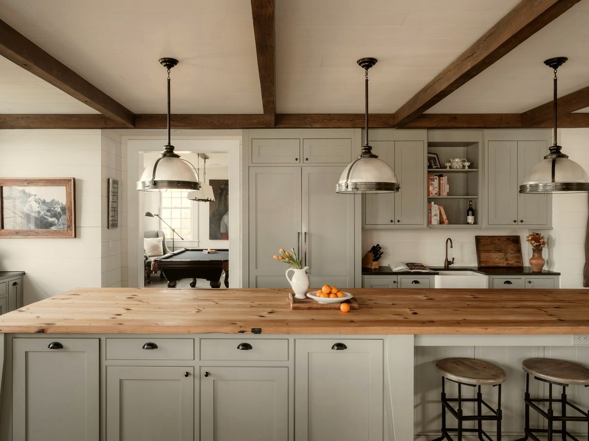 Renovated kitchen with quartz island, brass fittings and pendant lighting